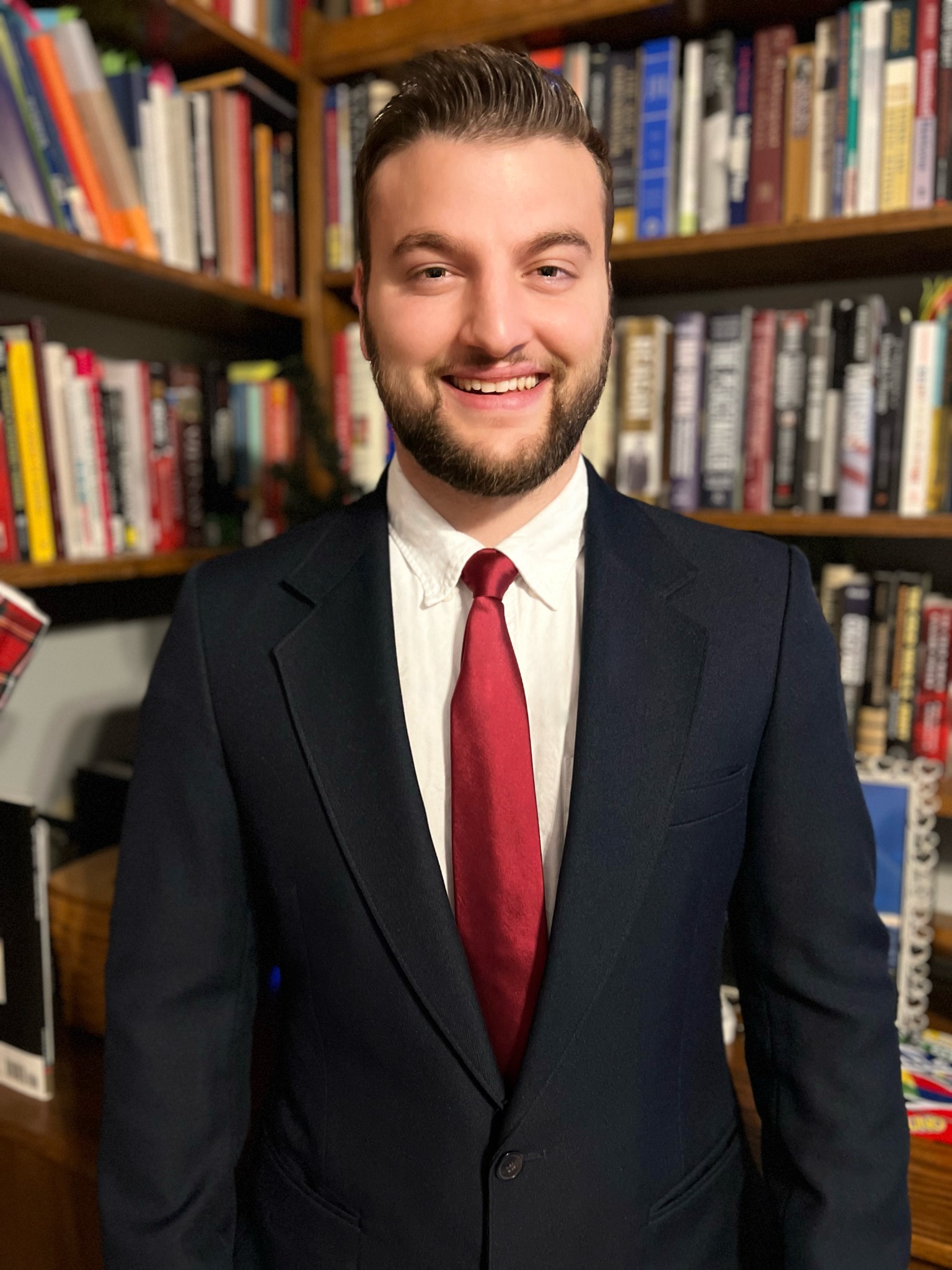 Portrait of Zachary Tayler in front of bookshelves