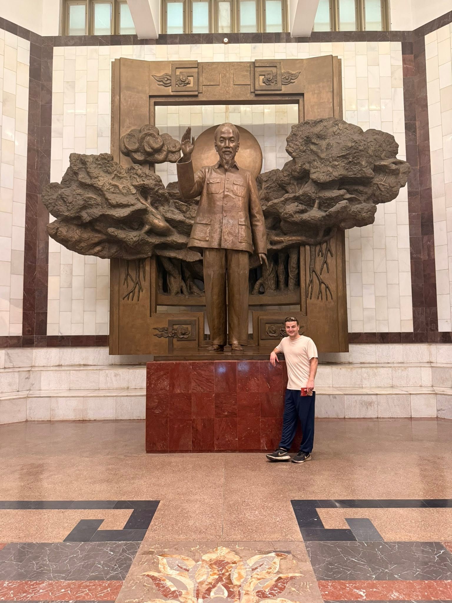Zachary Tayler beside a statue of Ho Chi Minh at the Ho Chi Minh Museum